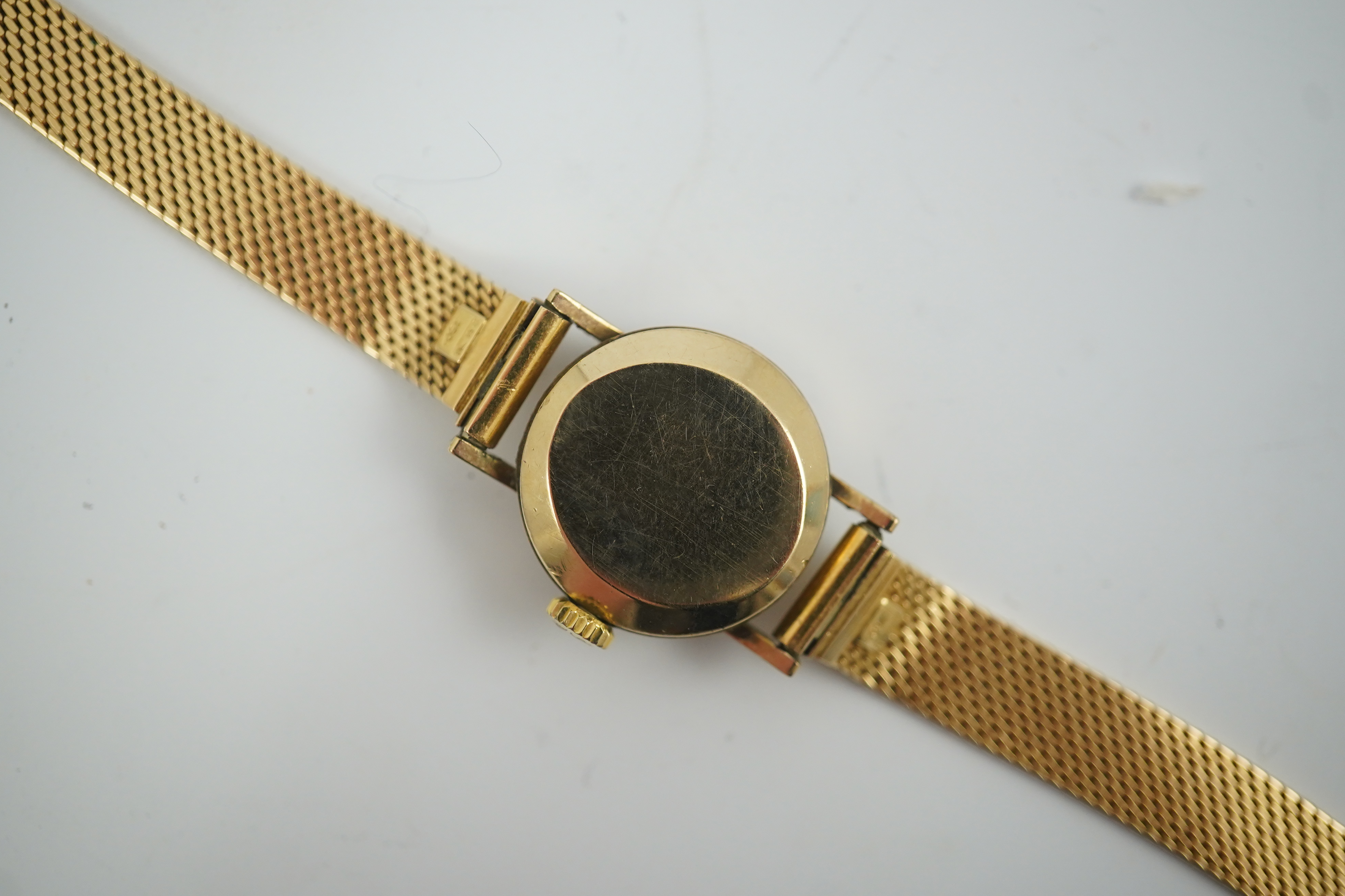 A lady's modern 9ct gold Longines manual wind wrist watch, on an Italian 18k gold bracelet